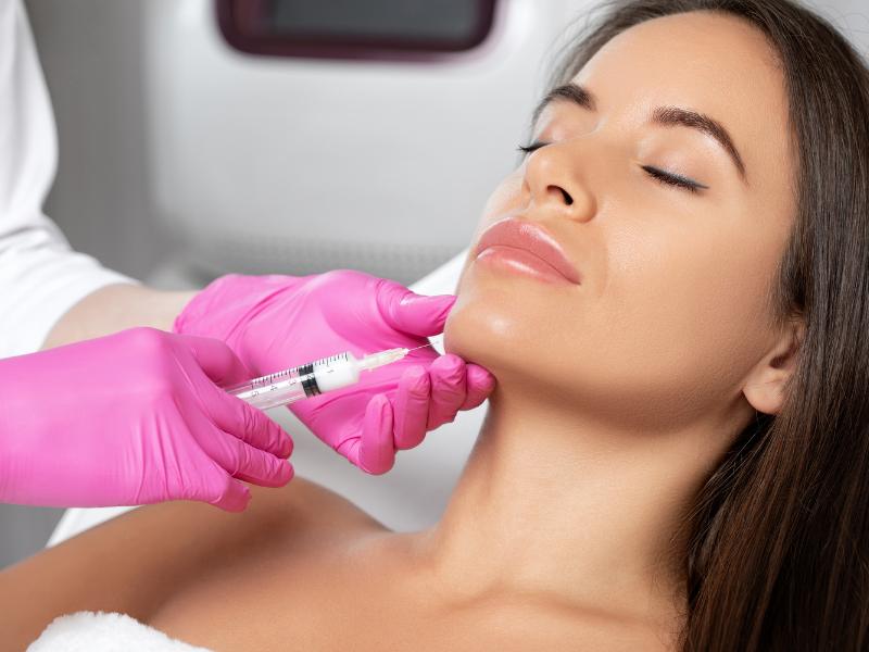 Aesthetic doctor injecting jawline filler for facial sculpting treatment