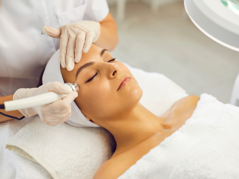 Woman receiving a professional skin resurfacing facial treatment at a clinic