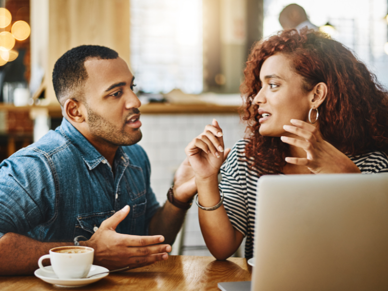 A couple having an engaged conversation over coffee in public