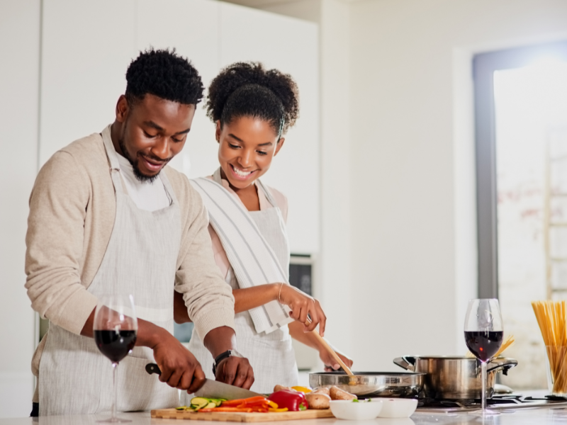 Happy couple preparing a meal together in a modern kitchen