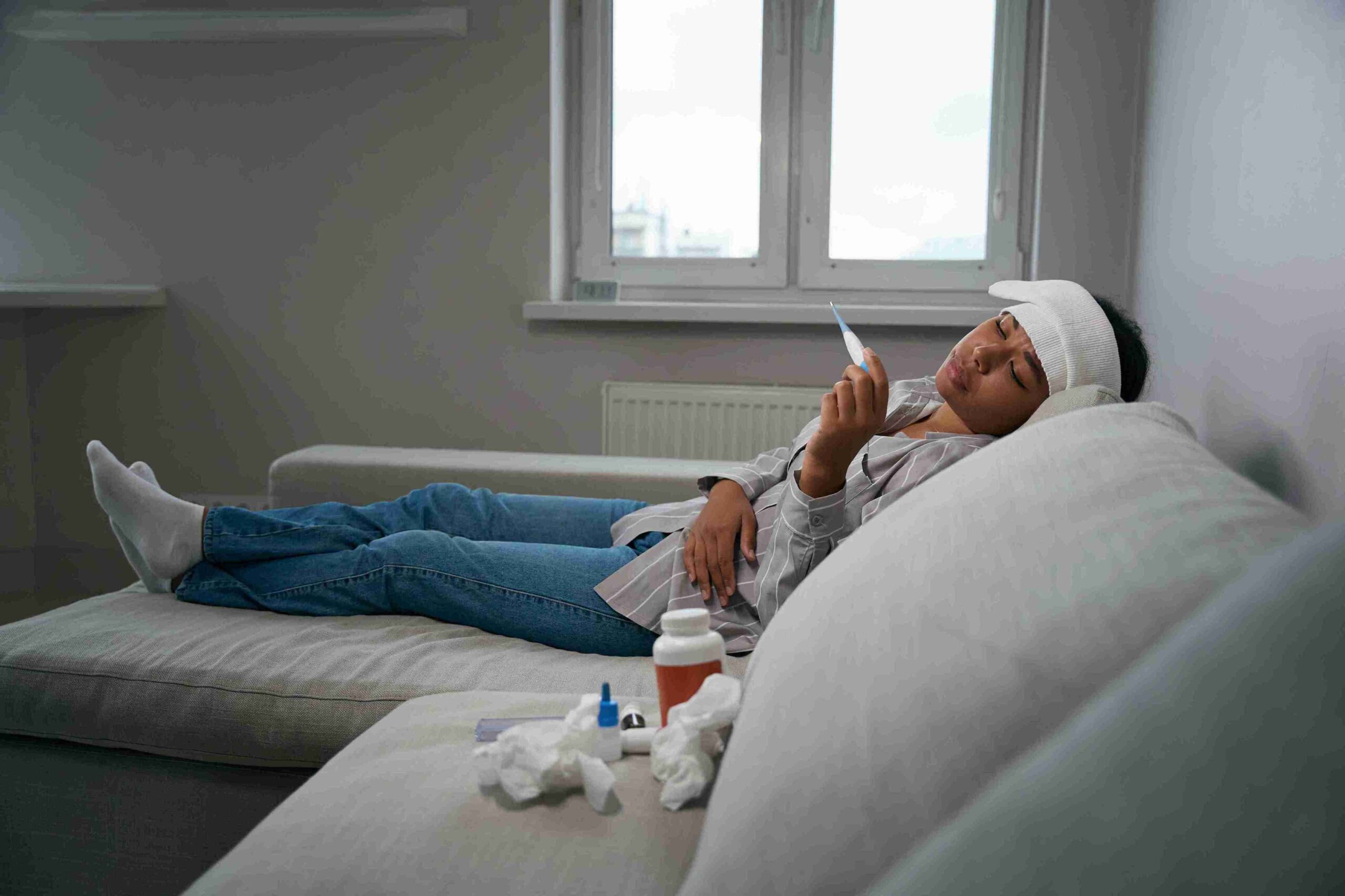 sick woman lying on the couch