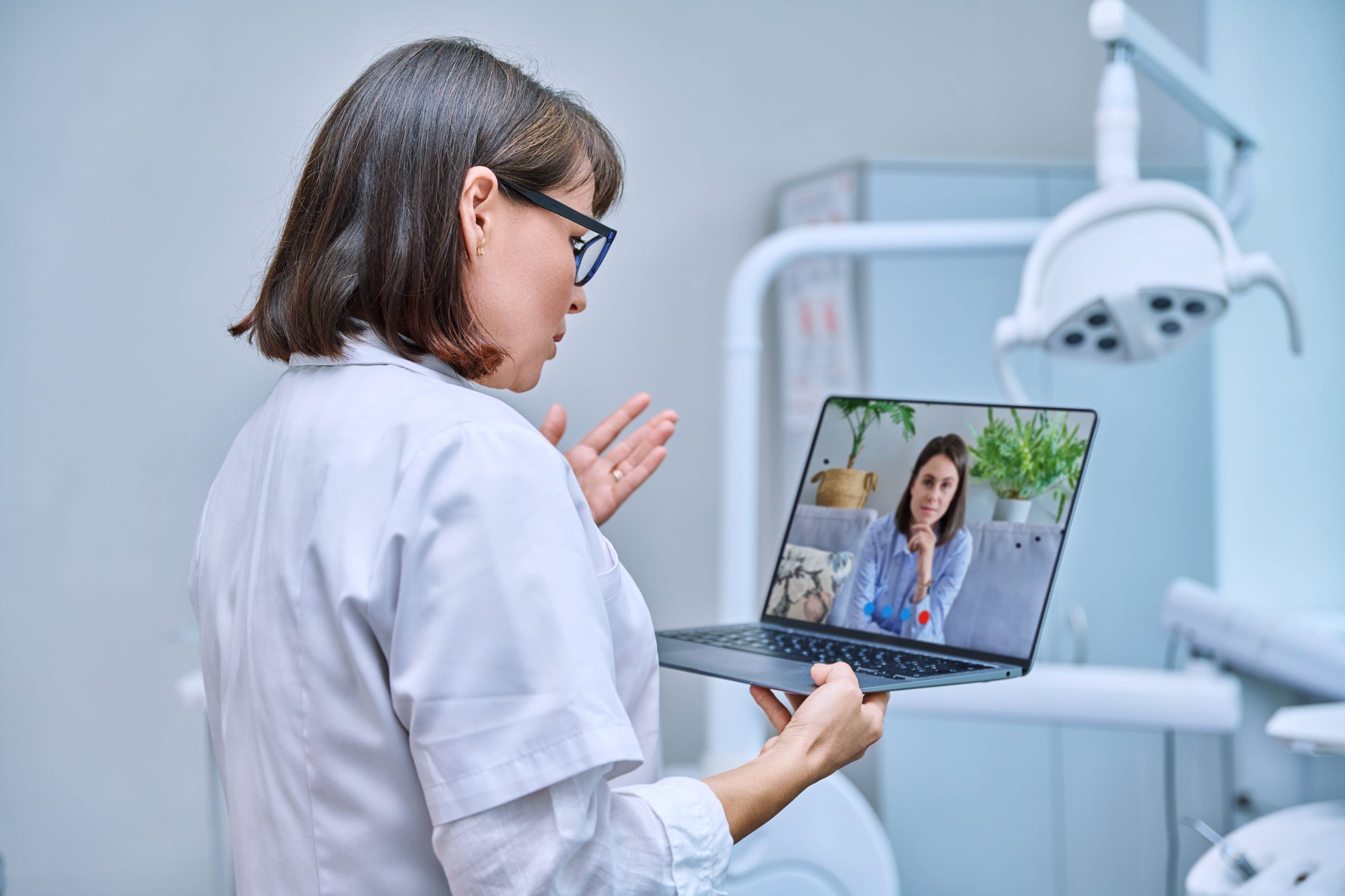 female doctor speaking with a patient through video call