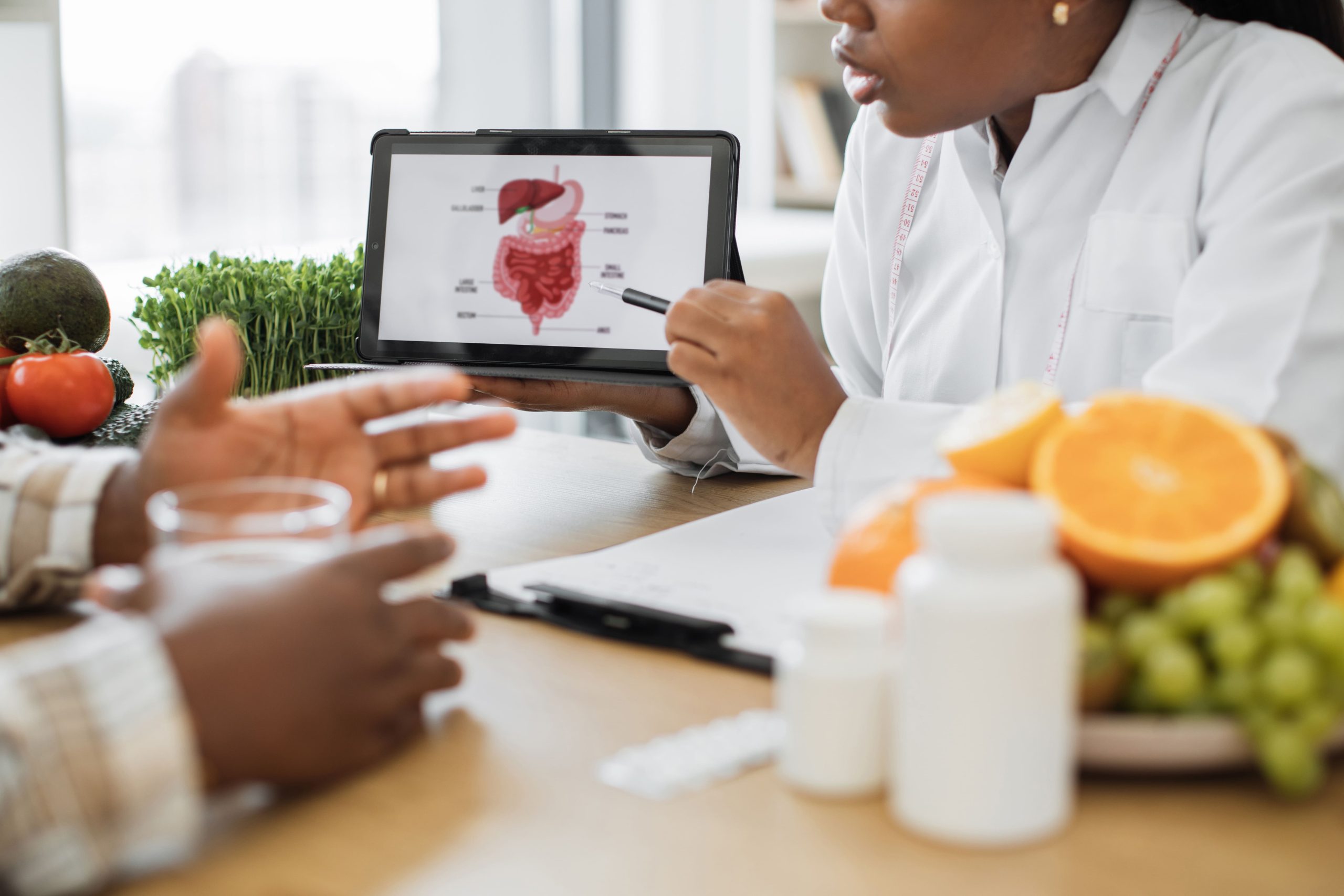 woman doctor explaining about the colon to a patient