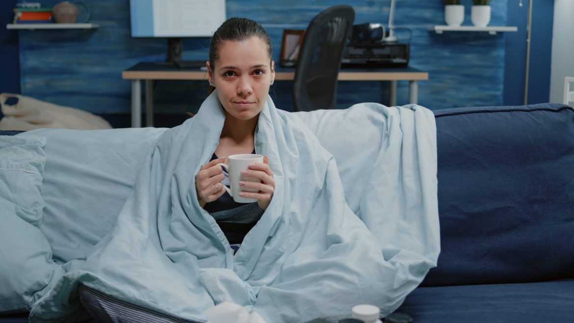 woman with a flu sitting on the couch