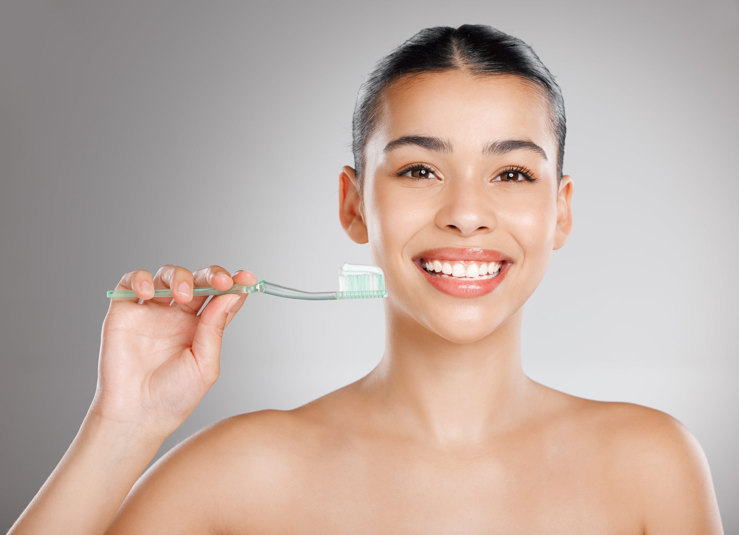 young woman about to brush her teeth