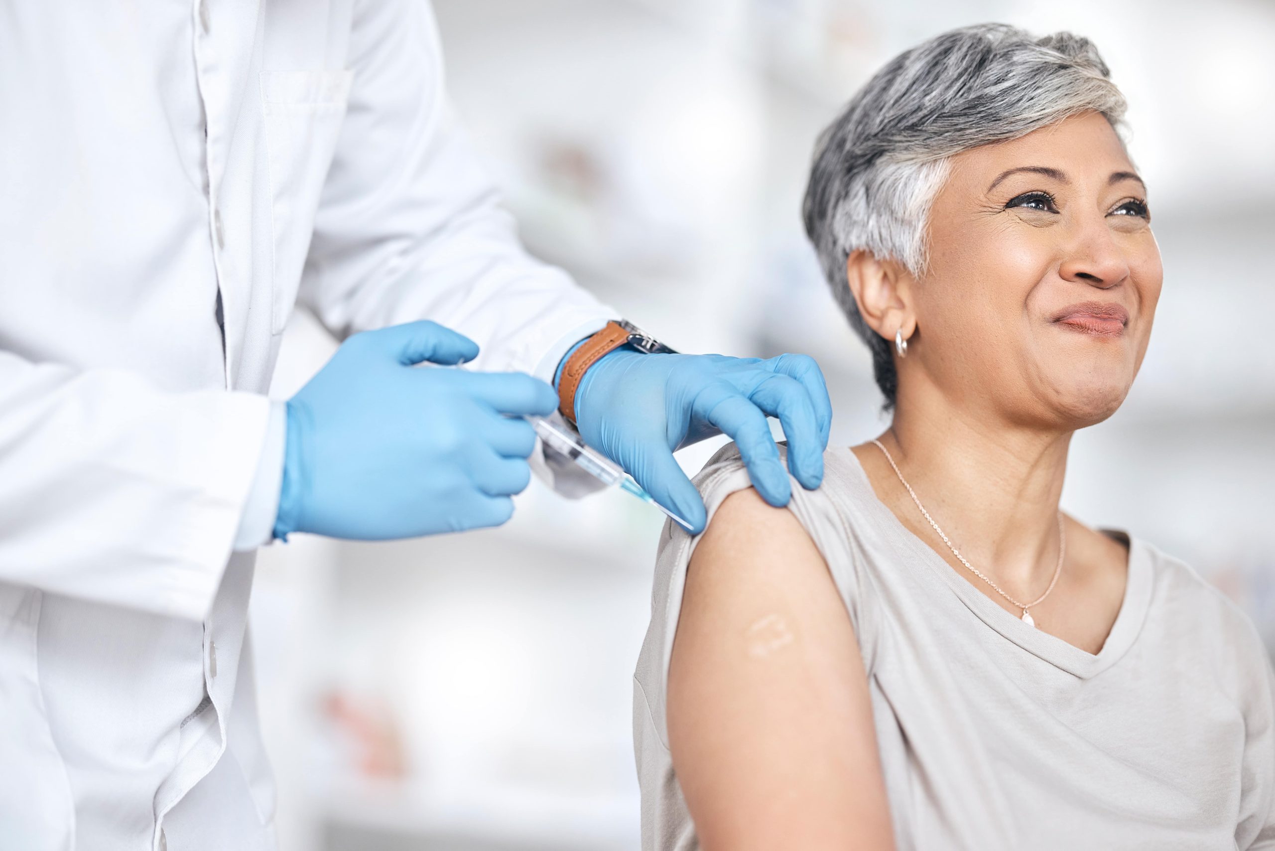elderly woman smiling after getting vaccinated