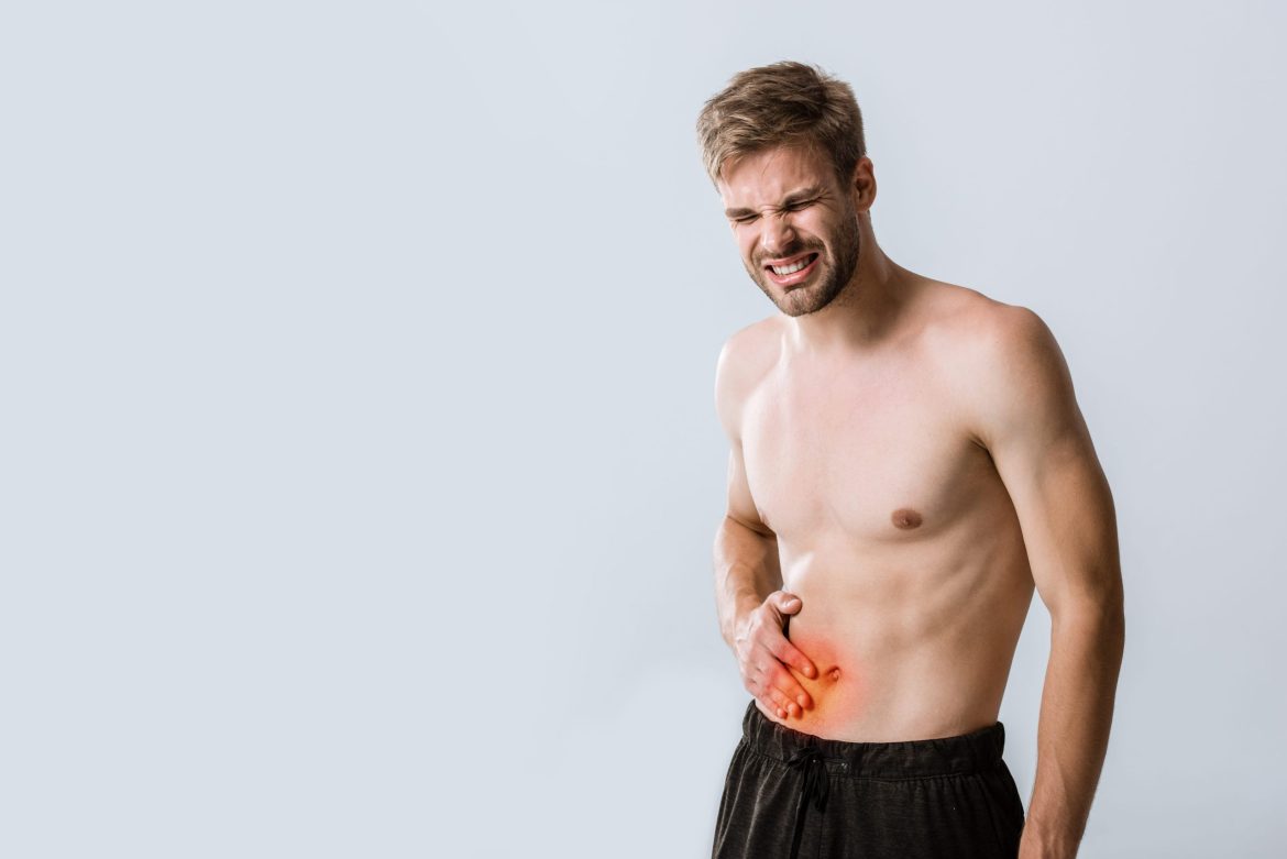 shirtless man with stomach pain