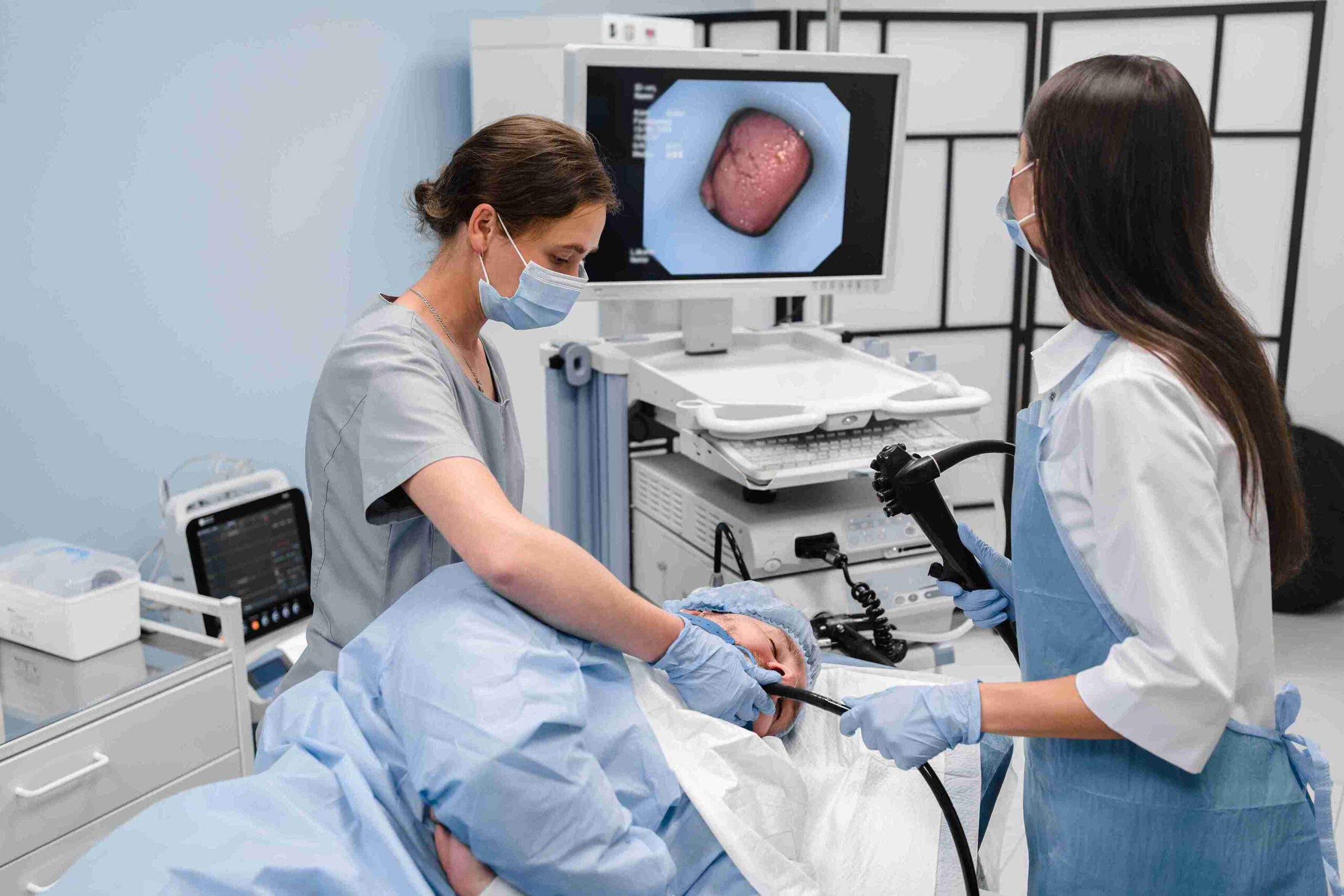 doctors performing a gastroscopy on a patient