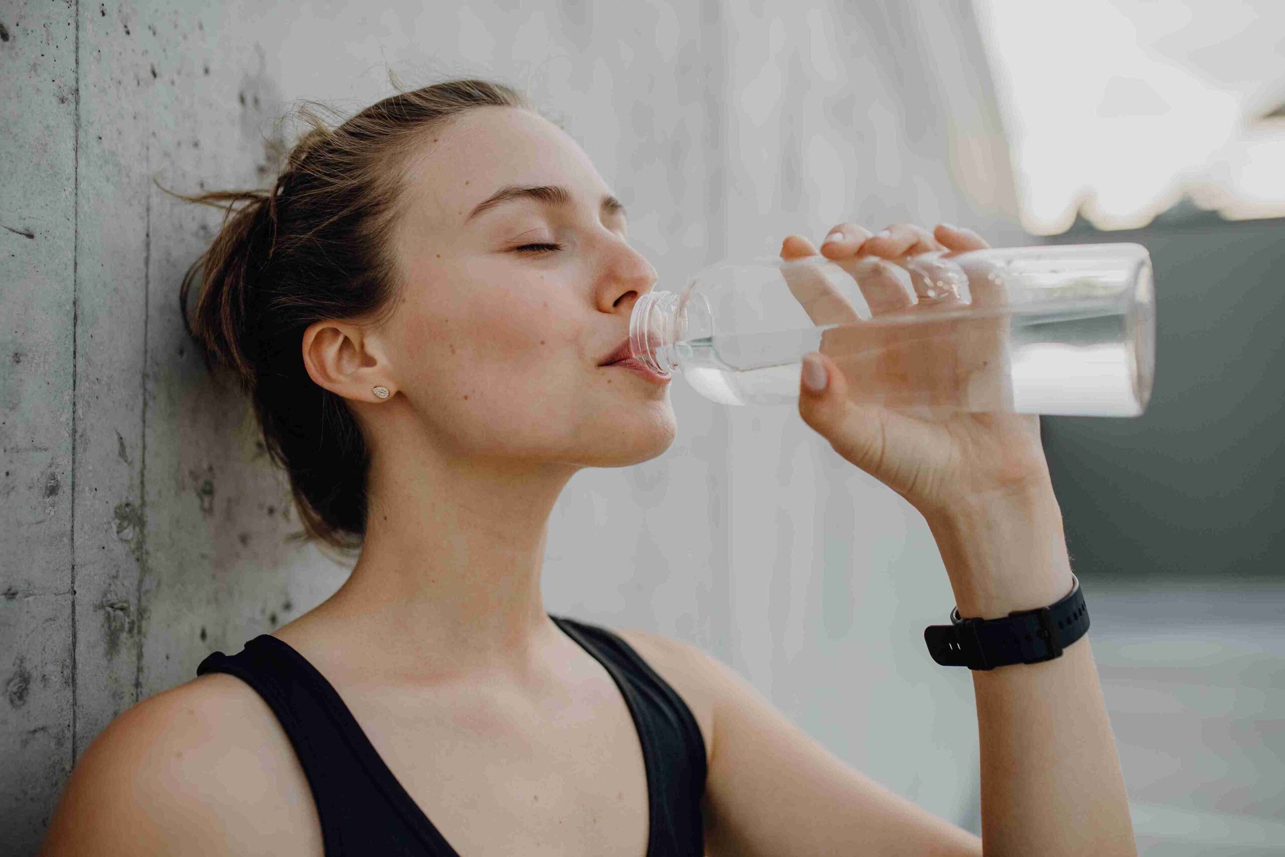 woman hydrating by drinking water