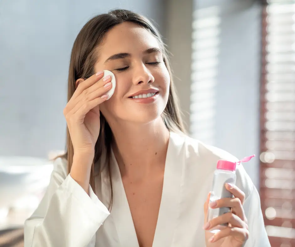 Woman applying toner with cotton pad for a fresh face