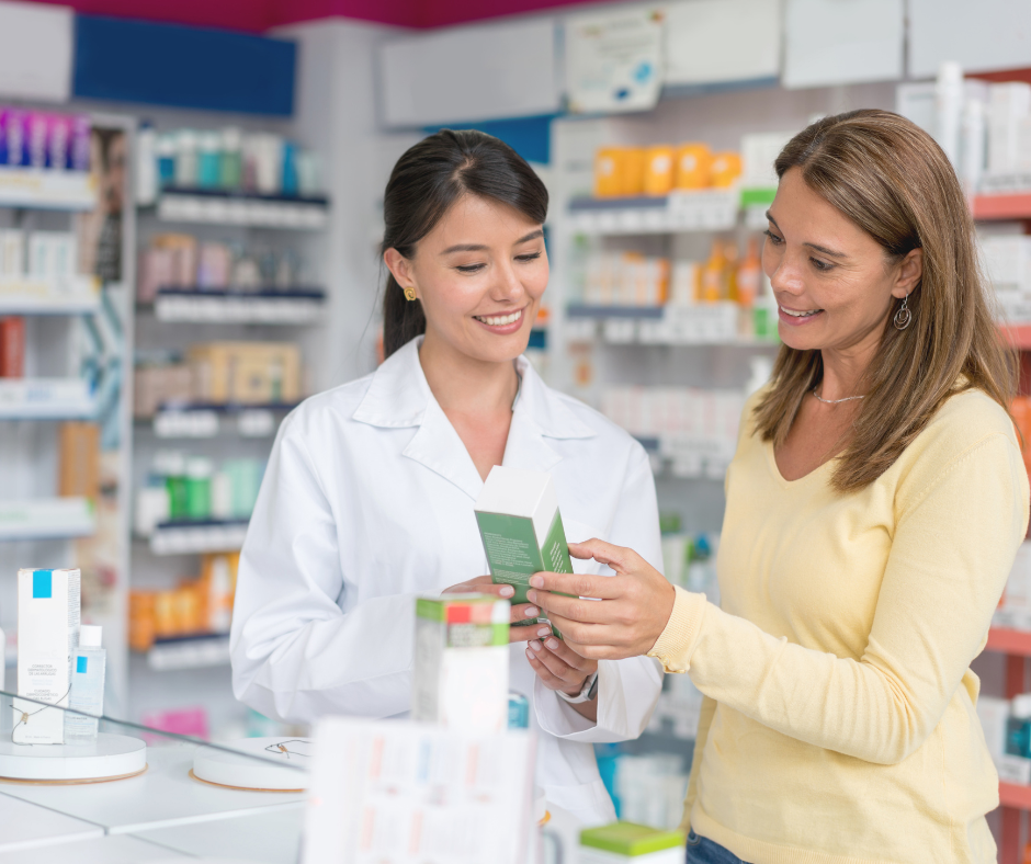 A friendly pharmacist assisting a customer with a skincare product in a well-stocked pharmacy