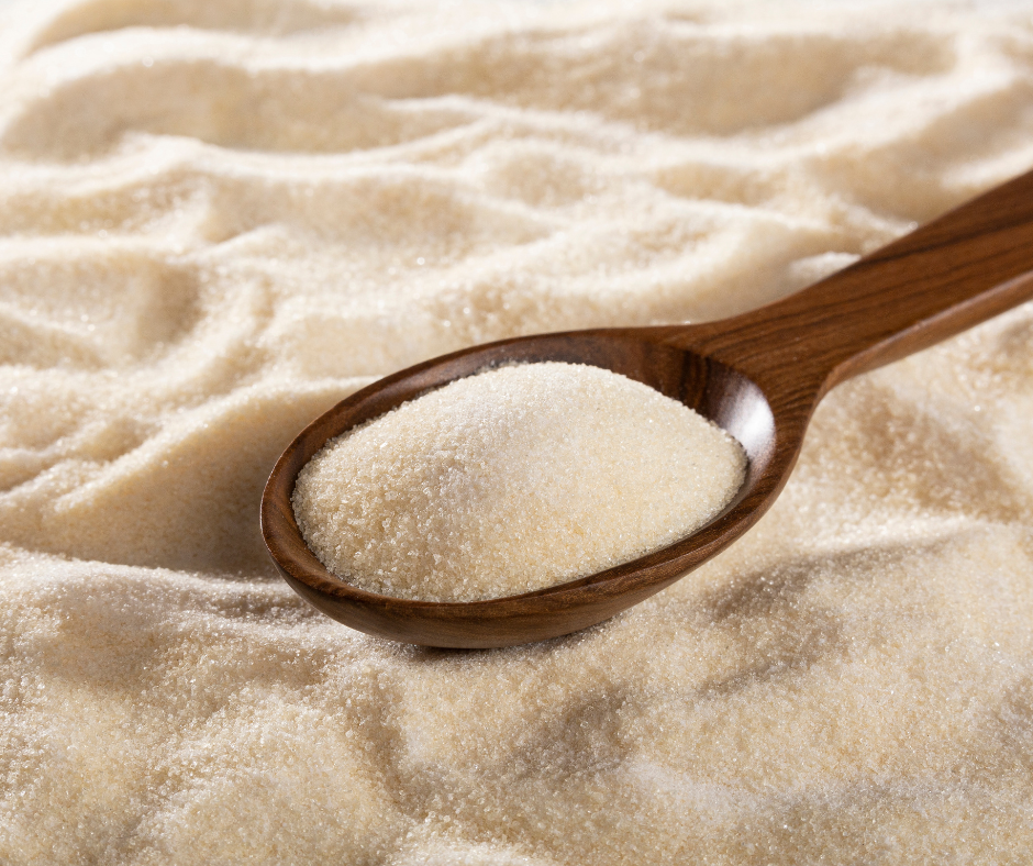 Wooden spoon filled with fine collagen powder for skincare