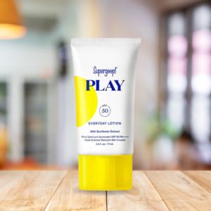 Supergoop! PLAY SPF 50 Bottleon a wooden table in the living room