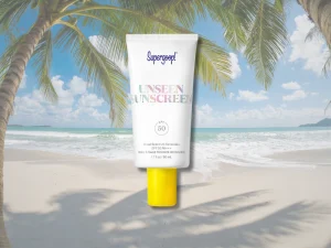 Supergoop! Unseen Sunscreen SPF 50 bottle with beach background