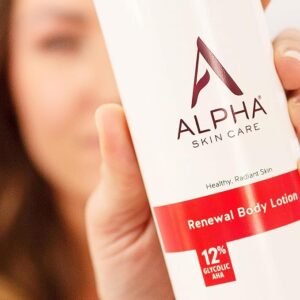 Alpha Skin Care Lotion held up close to the camera by a woman