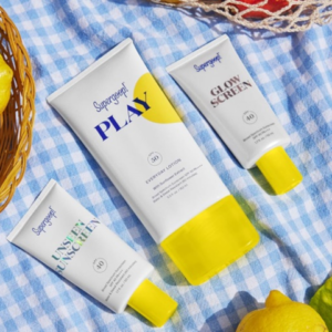 Supergoop! PLAY SPF 50 Lotion and sunscreens on a blue and white picnic blanket