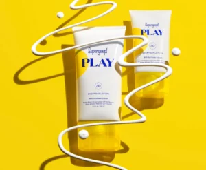 Supergoop! PLAY SPF 50 Bottles on a yellow background and string of lotion products coming from top to bottom.