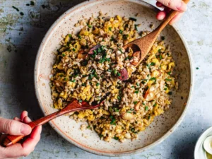 A bowl of garlic fried rice with egg and scallions
