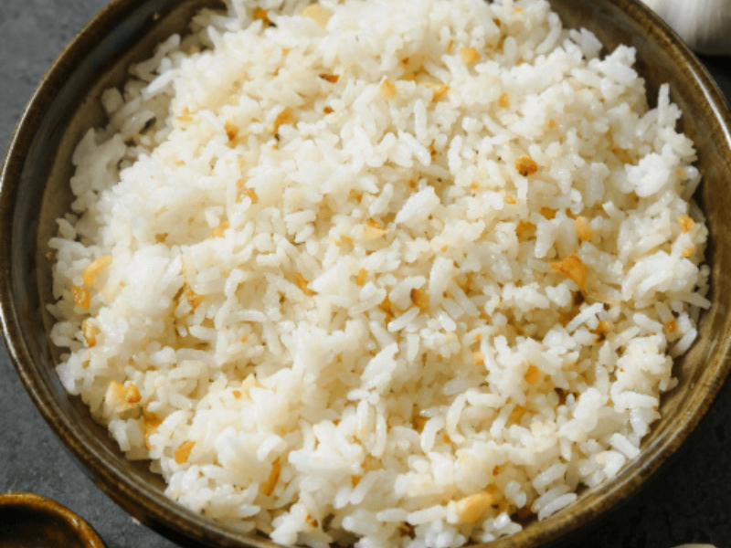 A bowl of garlic fried rice with golden crispy bits