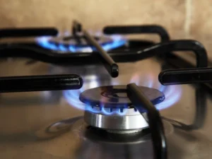 Blue flames burning on a gas stove burner in kitchen