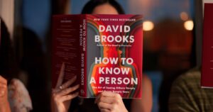 a woman holding the book in front of her face