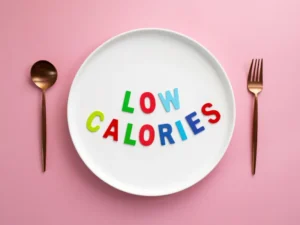 White plate with colorful "Low Calories" text and cutlery