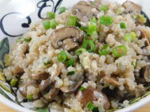 A bowl of creamy mushroom risotto topped with green onions