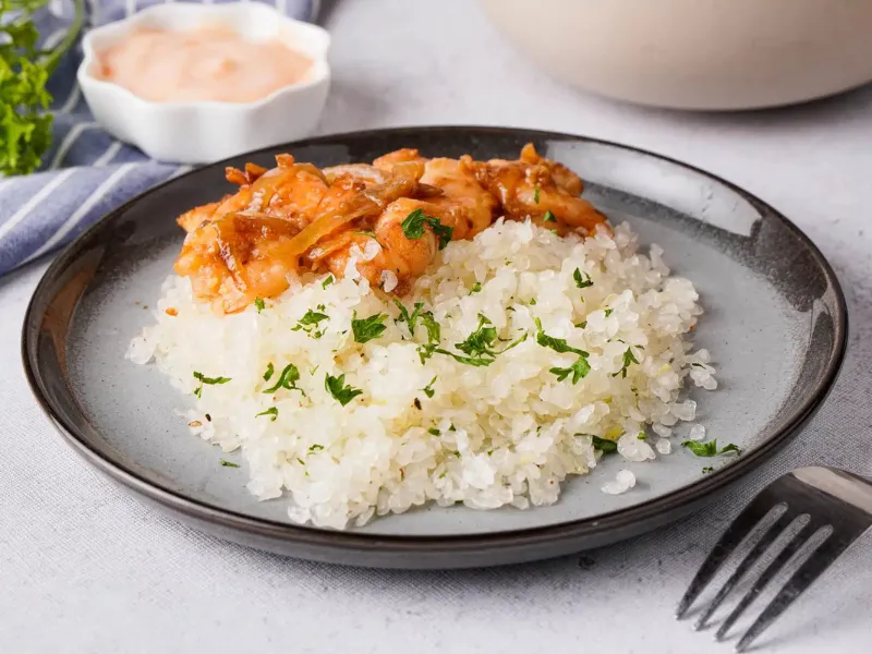 Shirataki rice with shrimp and sauce served on a plate