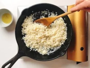 Cooking shirataki rice in a cast iron skillet with oil