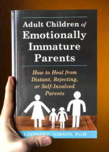 Adult Children of Emotionally Immature Parents Book being held by a hand