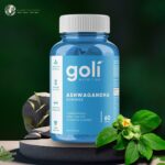 Goli Ashwagandha Gummies Bottle on a rock platform with Ashwagandha leaves