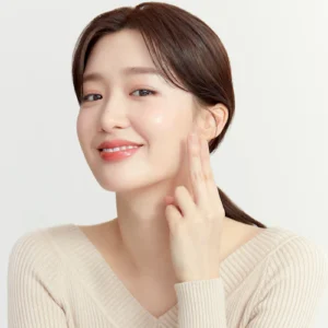 a beautiful asian woman touching her face