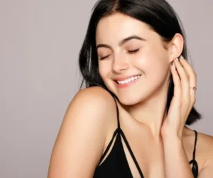 a beautiful woman with radiant skin posing happily at the camera