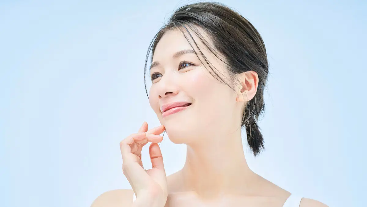 beautiful asian woman plump clear skin looking to the left smiling