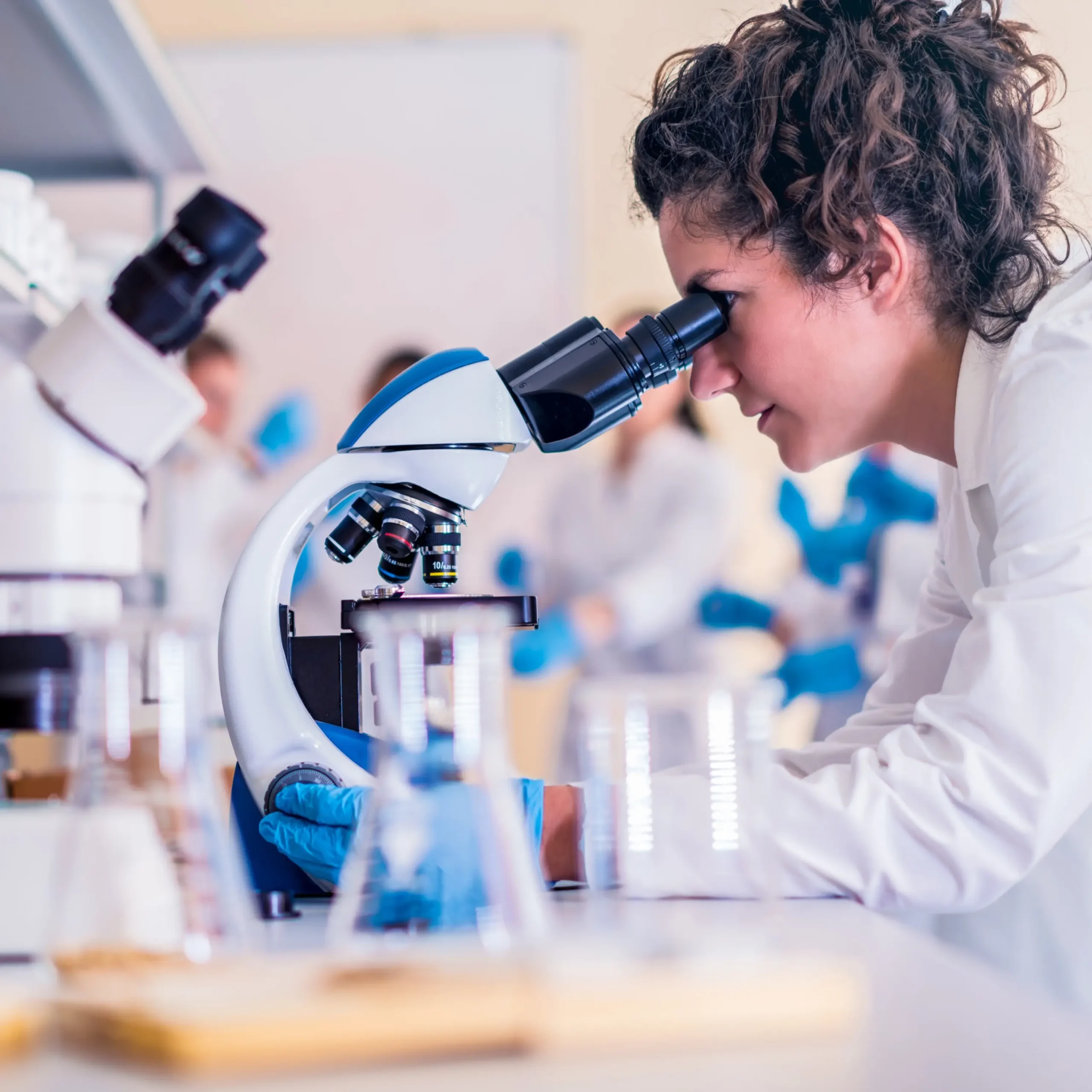 researchers studying glutathione and collagen under a microscope
