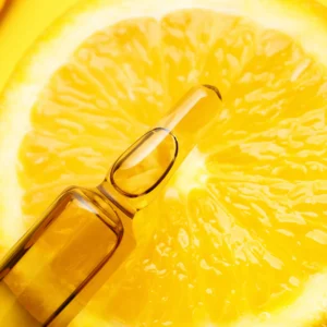 vitamin c in a bottle and lemon in the background