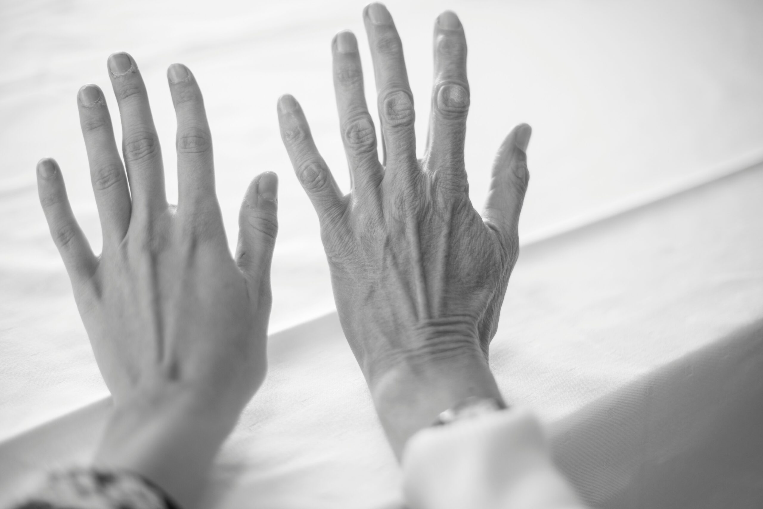 two hands, one is youthful, one is ageing