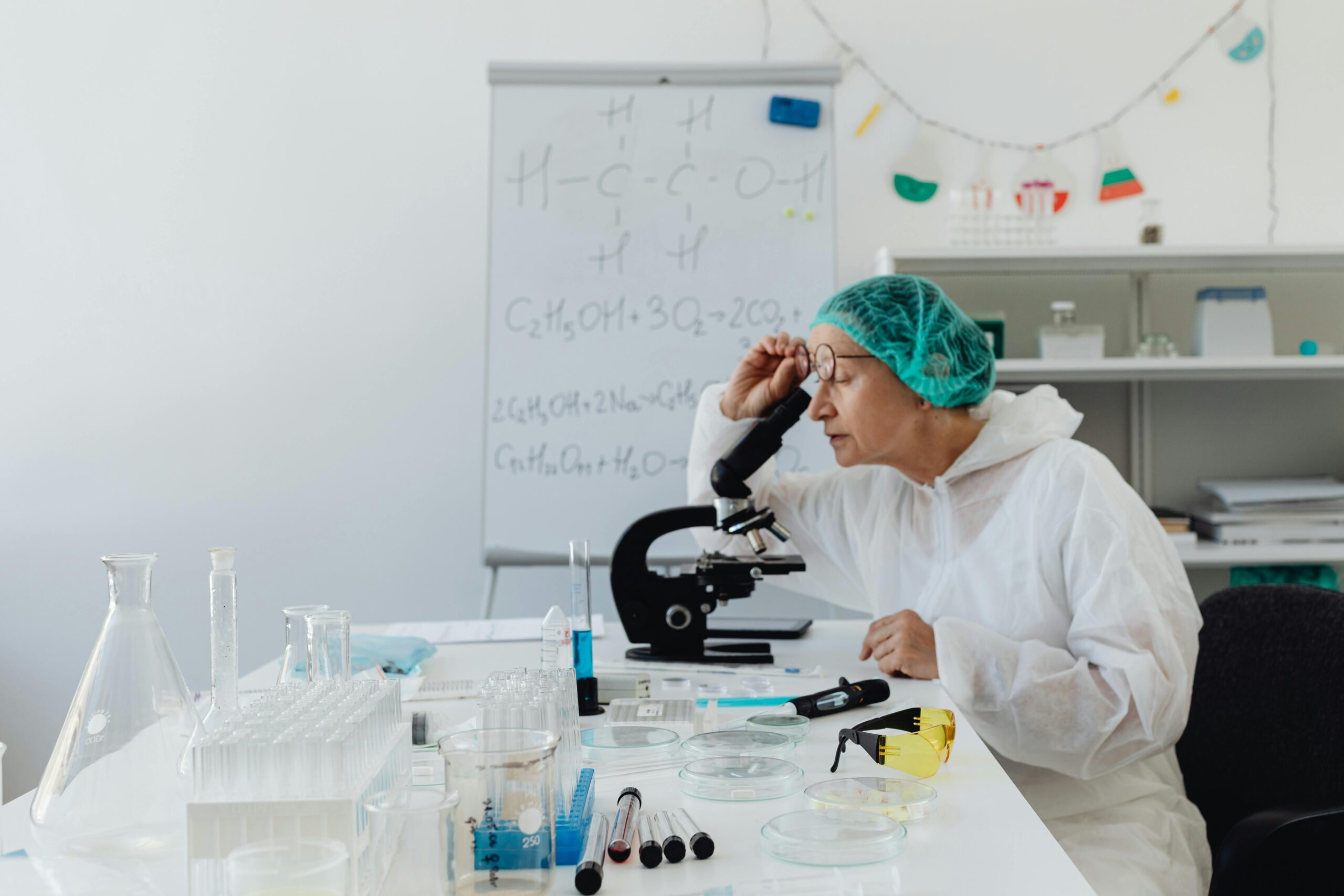 woman looking through a microscope