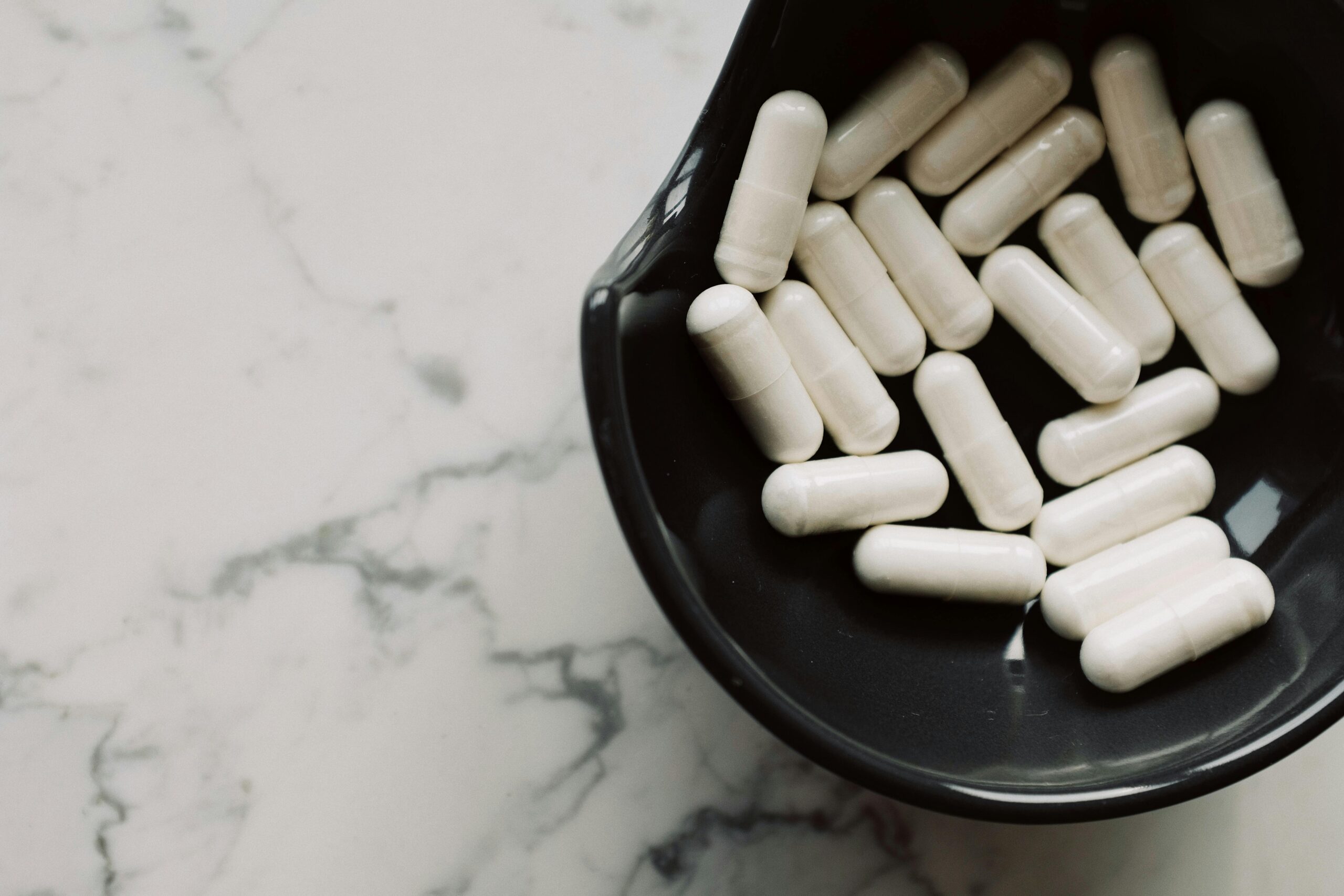 white medication pill on black ceramic bowl